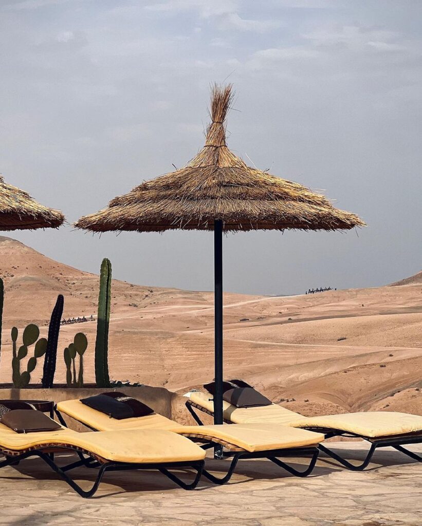 towering cliffs, Agafay Desert, Marrakech, Scenic view of golden sand dunes and barren landscape in Agafay Desert, Morocco.