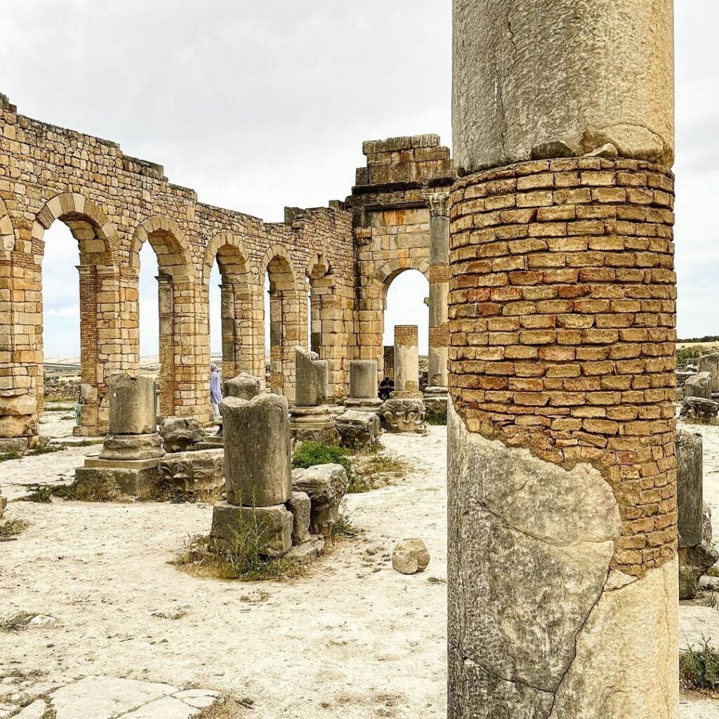View of ancient Roman ruins and intricate mosaics at Volubilis, Morocco.